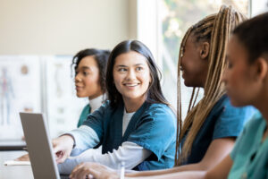 Image of a group of people in a classroom in scrubs